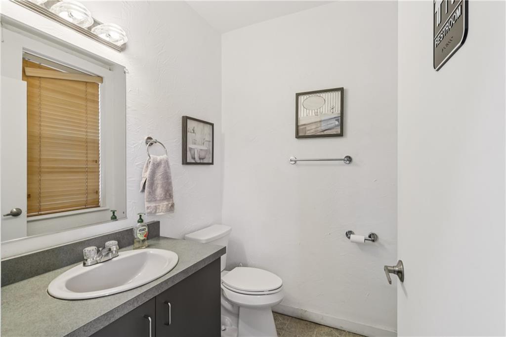 4723 Butler Street Pittsburgh, PA 15201 - Photo 13 of 47 a bathroom with a toilet sink and mirror