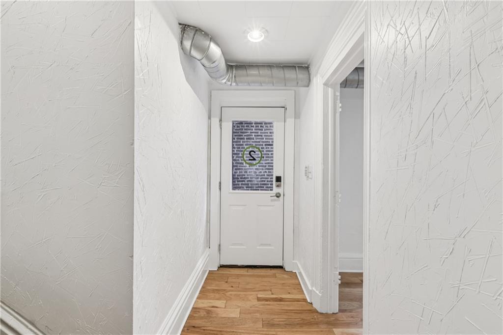 4723 Butler Street Pittsburgh, PA 15201 - Photo 15 of 47 a view of a hallway with wooden floor and staircase