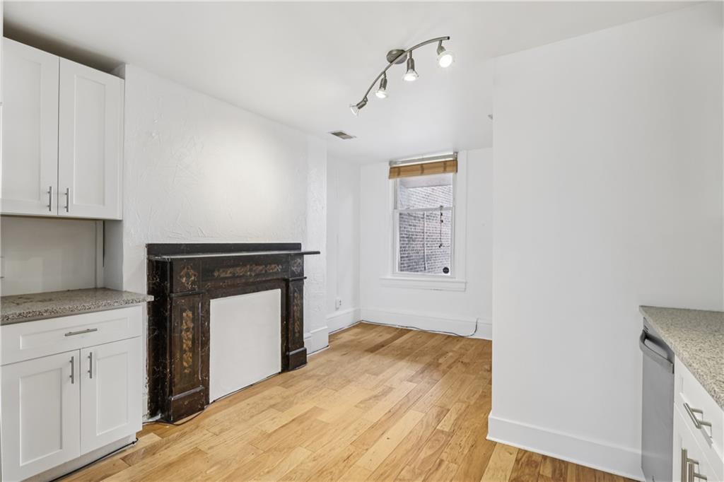 4723 Butler Street Pittsburgh, PA 15201 - Photo 20 of 47 a bedroom with a bed and a fireplace