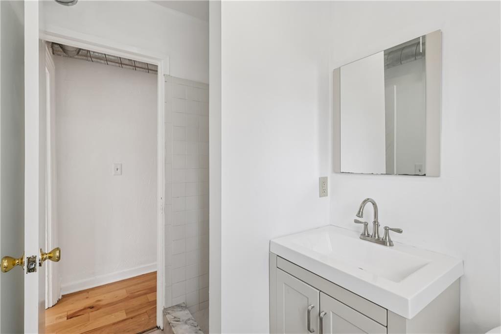 4723 Butler Street Pittsburgh, PA 15201 - Photo 28 of 47 a bathroom with a sink and a mirror