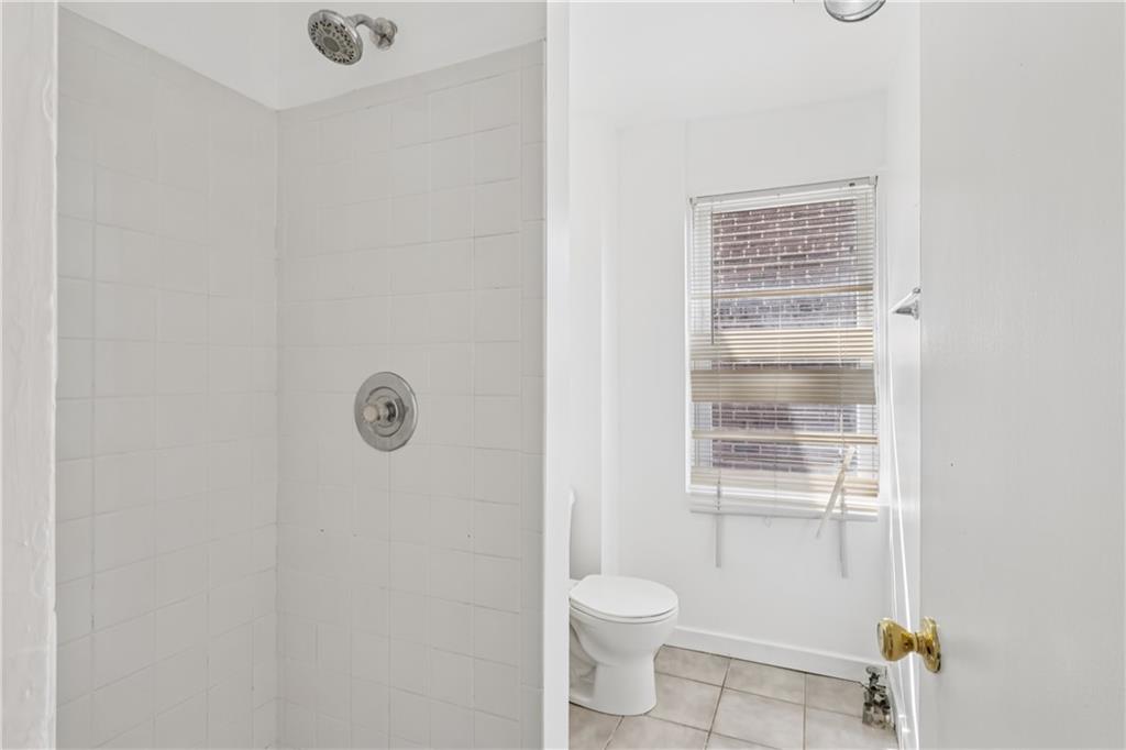 4723 Butler Street Pittsburgh, PA 15201 - Photo 29 of 47 a bathroom with a toilet a sink and a shower