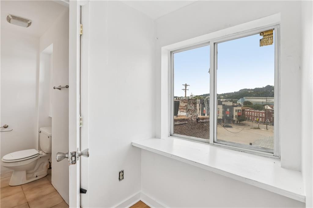 4723 Butler Street Pittsburgh, PA 15201 - Photo 33 of 47 a bathroom with a toilet and a shower