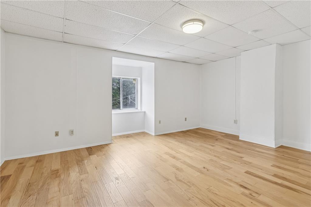 4723 Butler Street Pittsburgh, PA 15201 - Photo 36 of 47 an empty room with wooden floor and windows