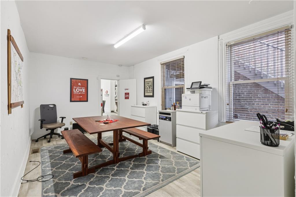 4723 Butler Street Pittsburgh, PA 15201 - Photo 10 of 47 a work room with furniture a flat screen tv and a table