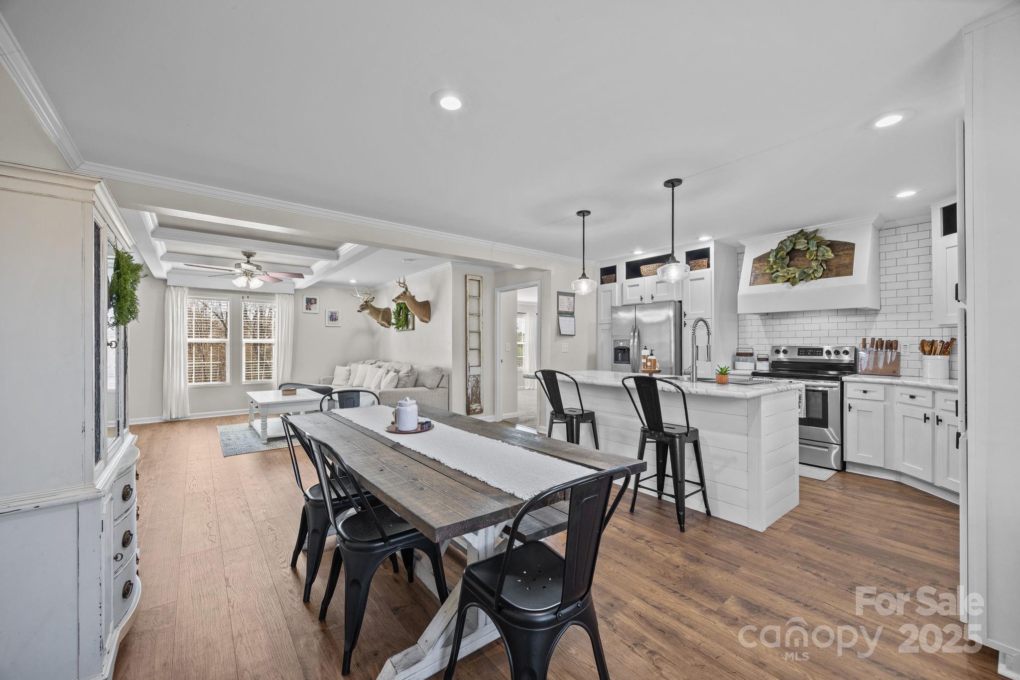 247 Aden Green Road Mill Spring, NC 28756 - Photo 13 of 48 a view of a dining room with furniture and wooden floor