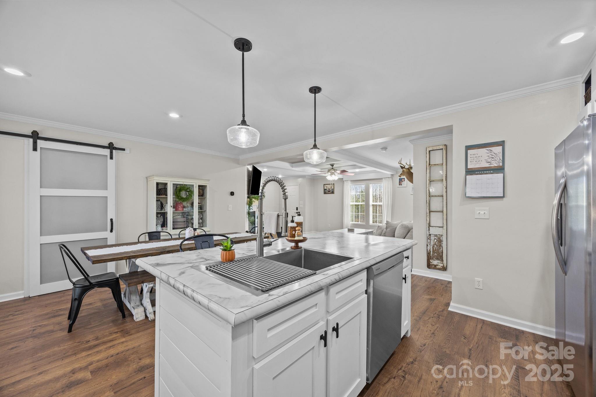 247 Aden Green Road Mill Spring, NC 28756 - Photo 18 of 48 a kitchen with stainless steel appliances granite countertop a sink and a refrigerator
