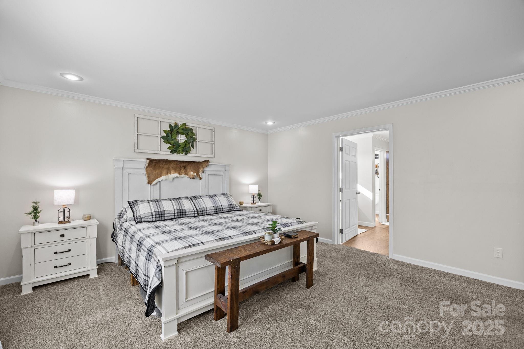 247 Aden Green Road Mill Spring, NC 28756 - Photo 22 of 48 a bedroom with a bed and a cabinets