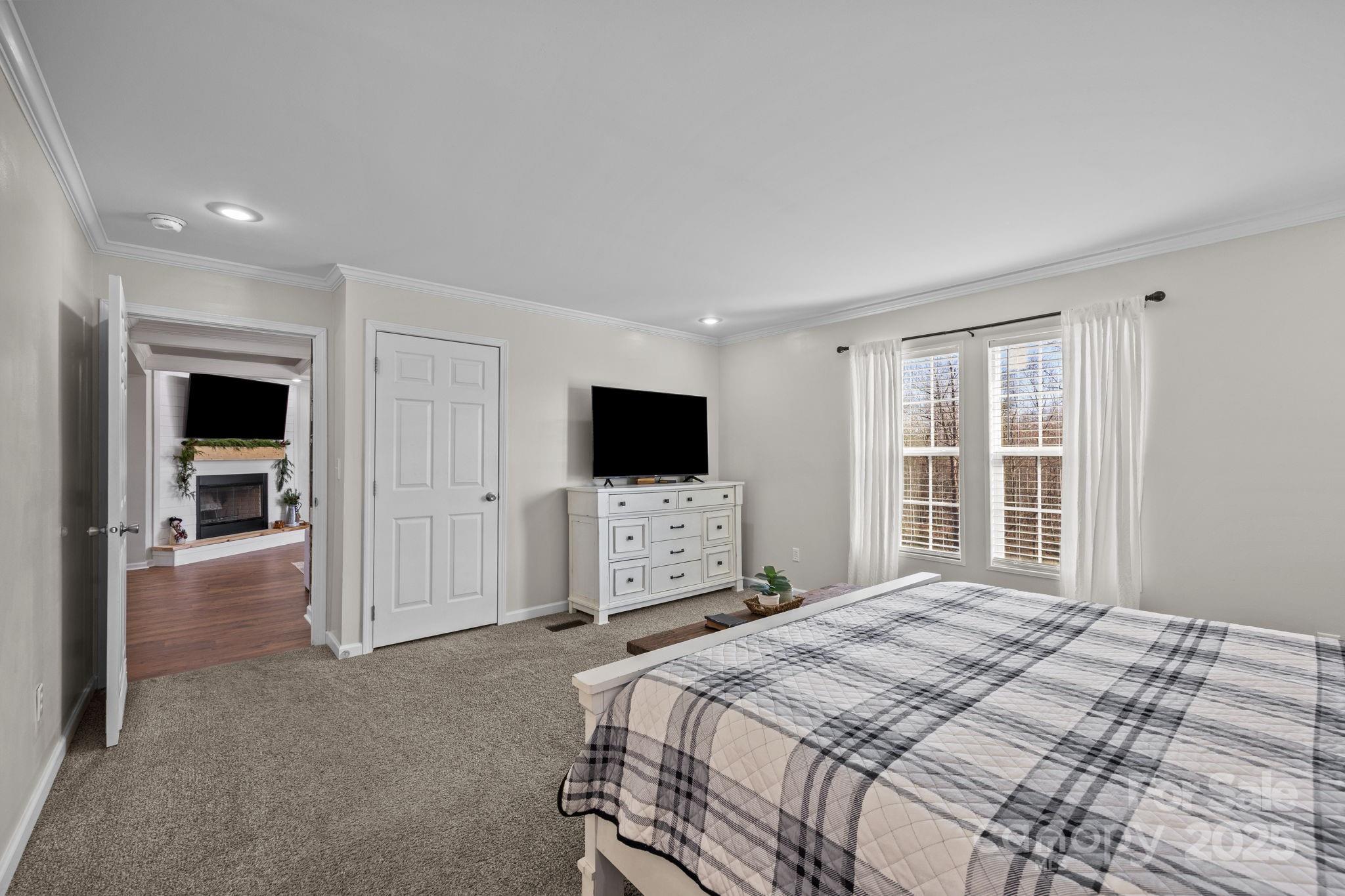 247 Aden Green Road Mill Spring, NC 28756 - Photo 24 of 48 a bedroom with a bed and a flat screen tv