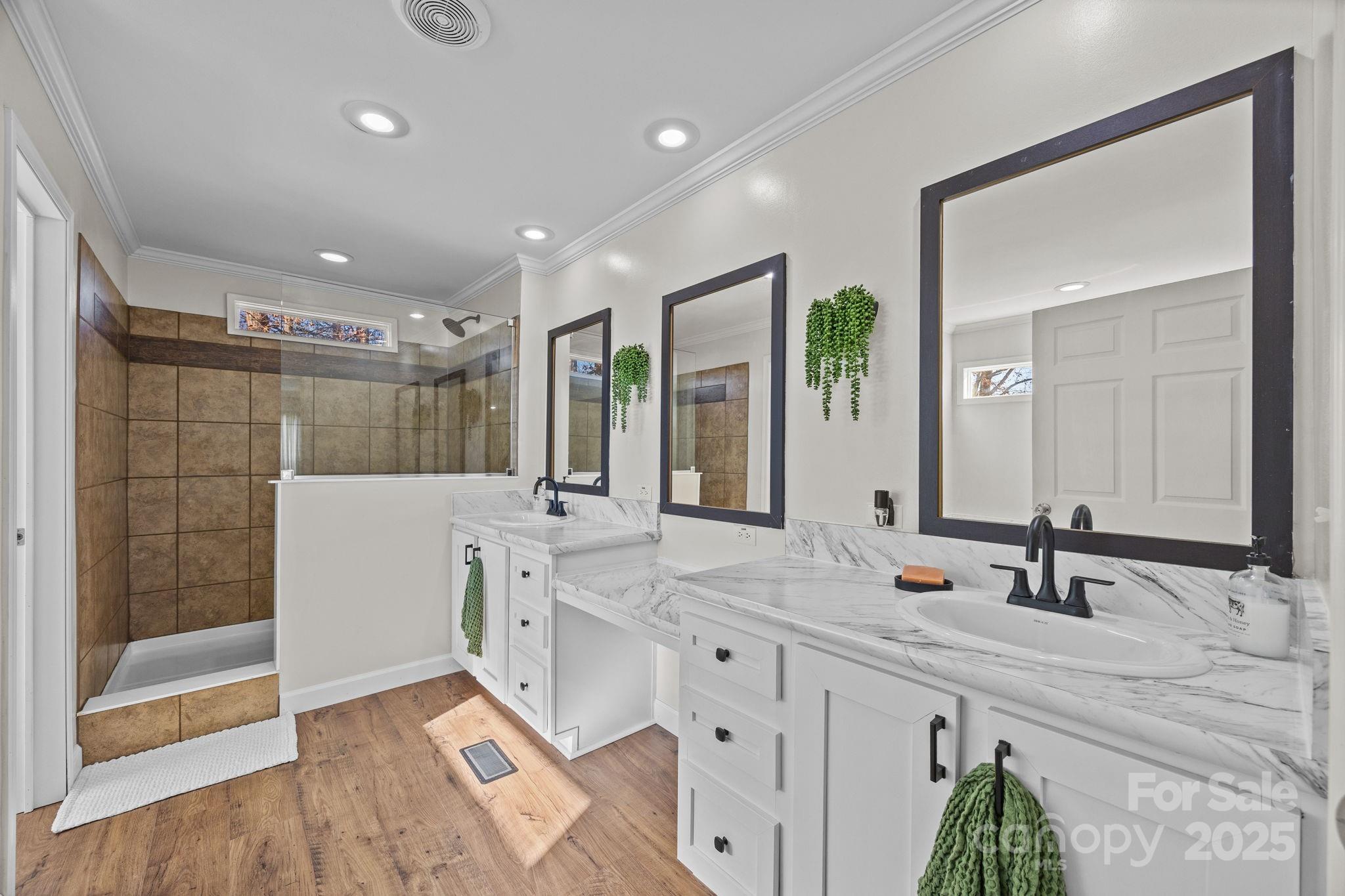 247 Aden Green Road Mill Spring, NC 28756 - Photo 25 of 48 a bathroom with a double vanity sink mirror and shower