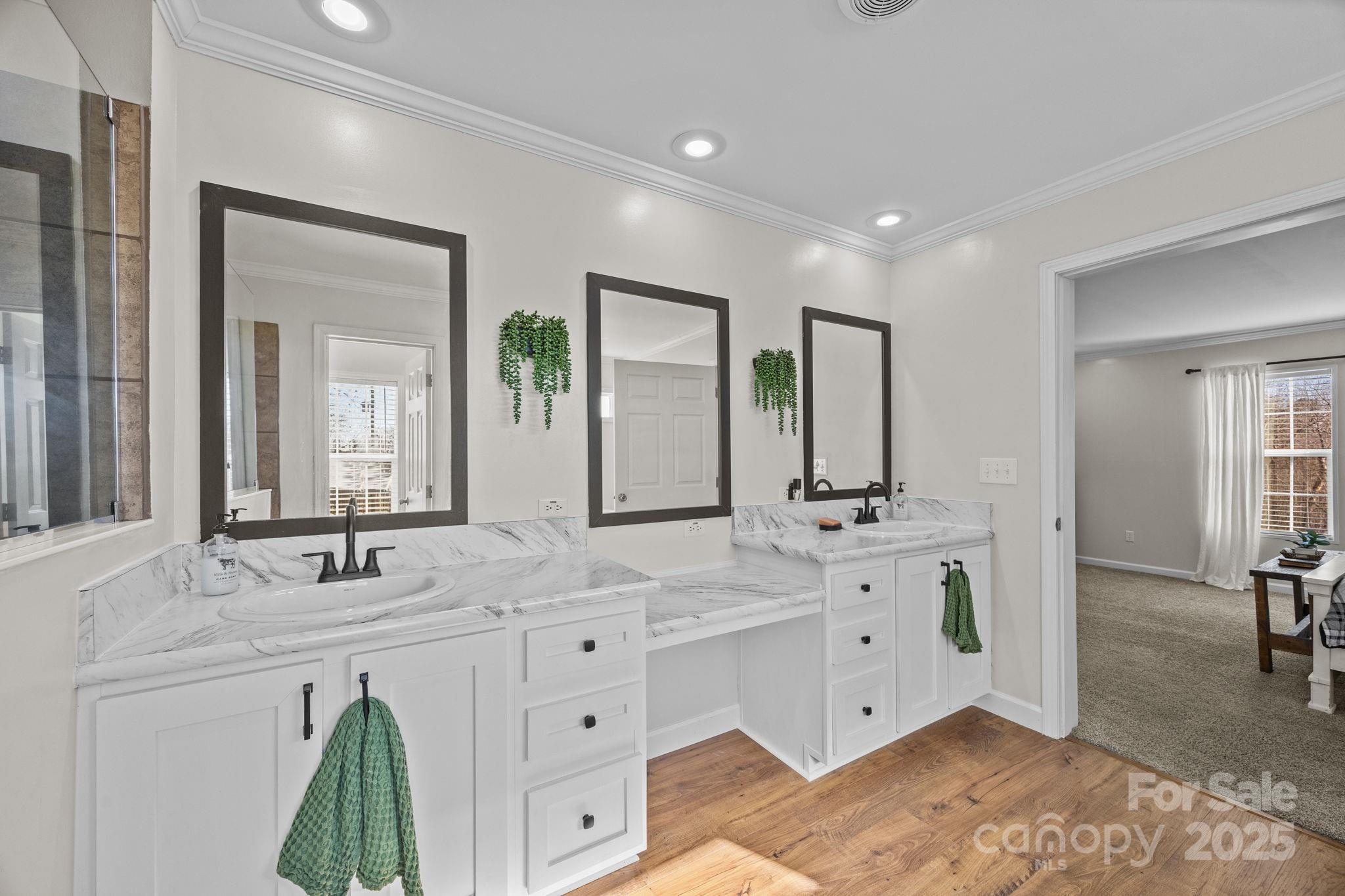 247 Aden Green Road Mill Spring, NC 28756 - Photo 26 of 48 a bathroom with a double vanity sink and mirror