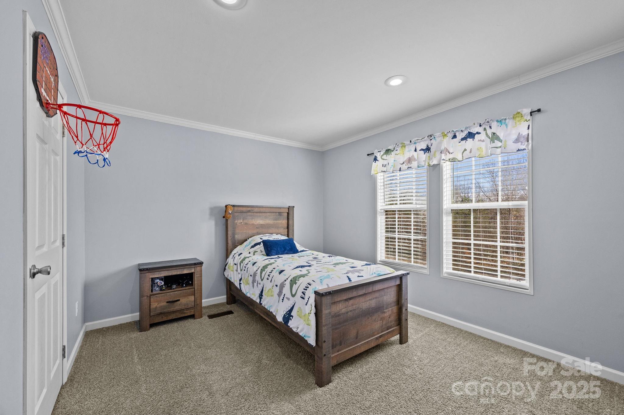 247 Aden Green Road Mill Spring, NC 28756 - Photo 28 of 48 a bedroom with a bed and a window