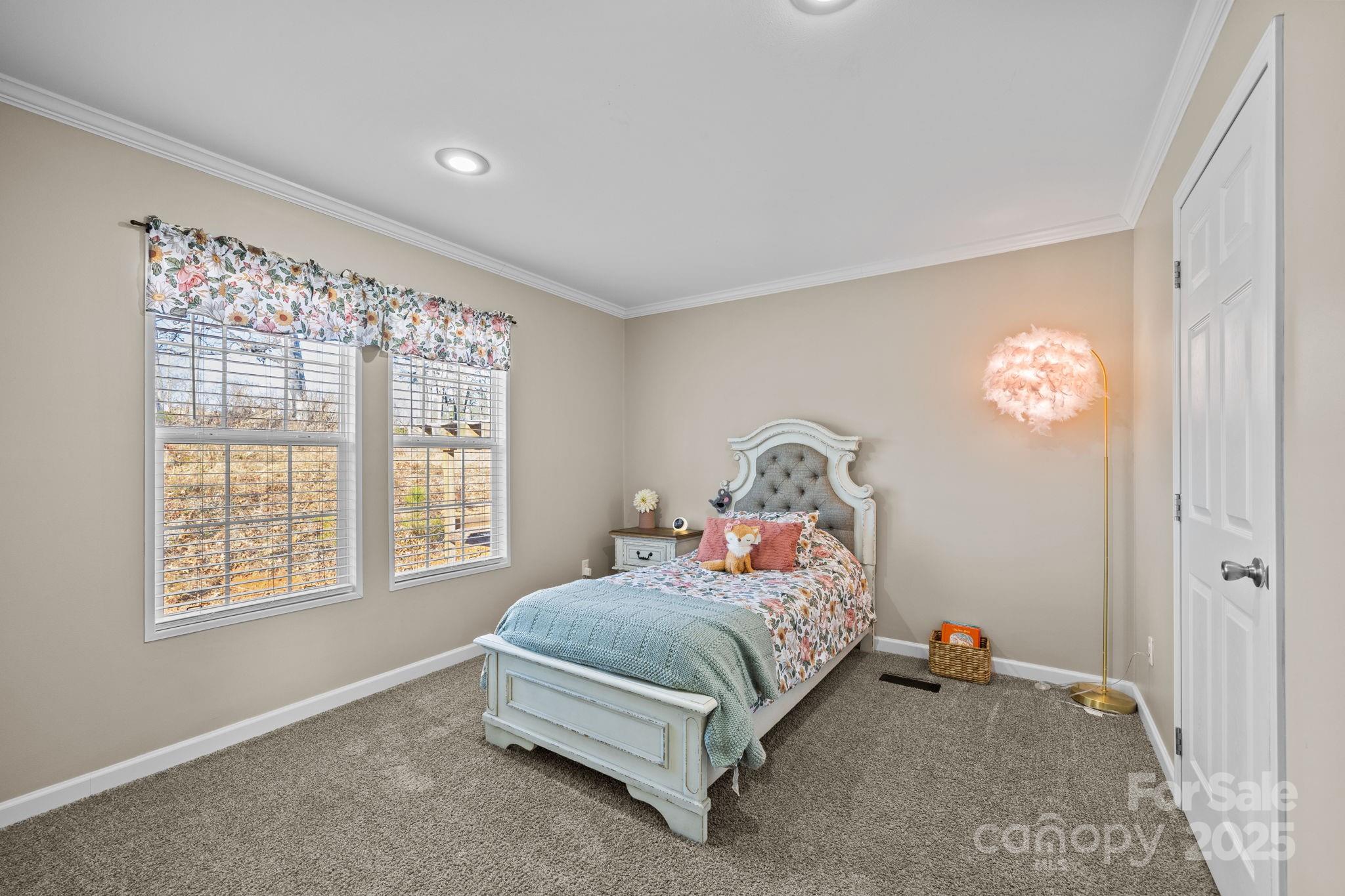 247 Aden Green Road Mill Spring, NC 28756 - Photo 30 of 48 a bedroom with a bed and a window