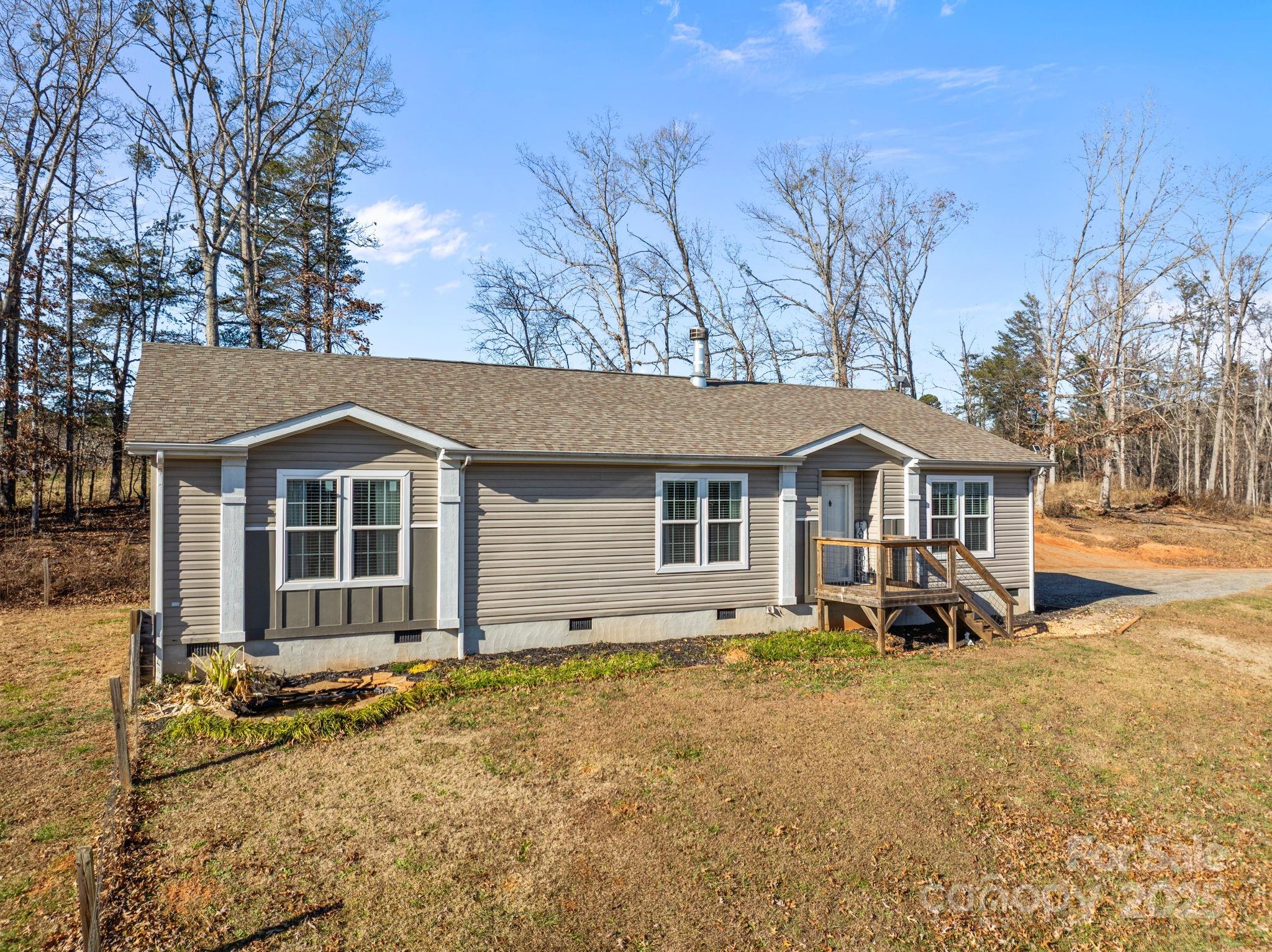 247 Aden Green Road Mill Spring, NC 28756 - Photo 35 of 48 a front view of a house with a yard