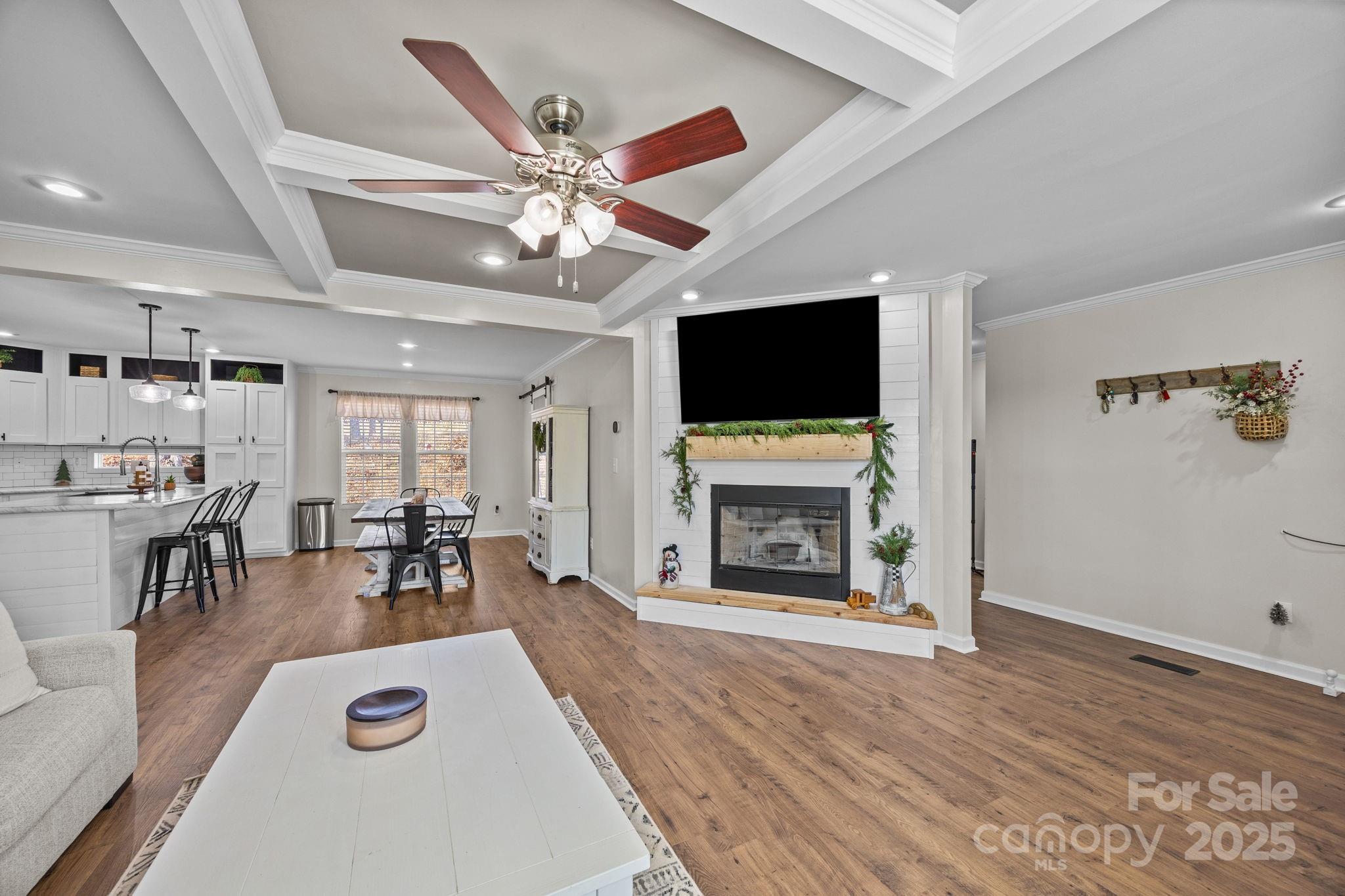 247 Aden Green Road Mill Spring, NC 28756 - Photo 8 of 48 a living room with furniture a flat screen tv and a fireplace