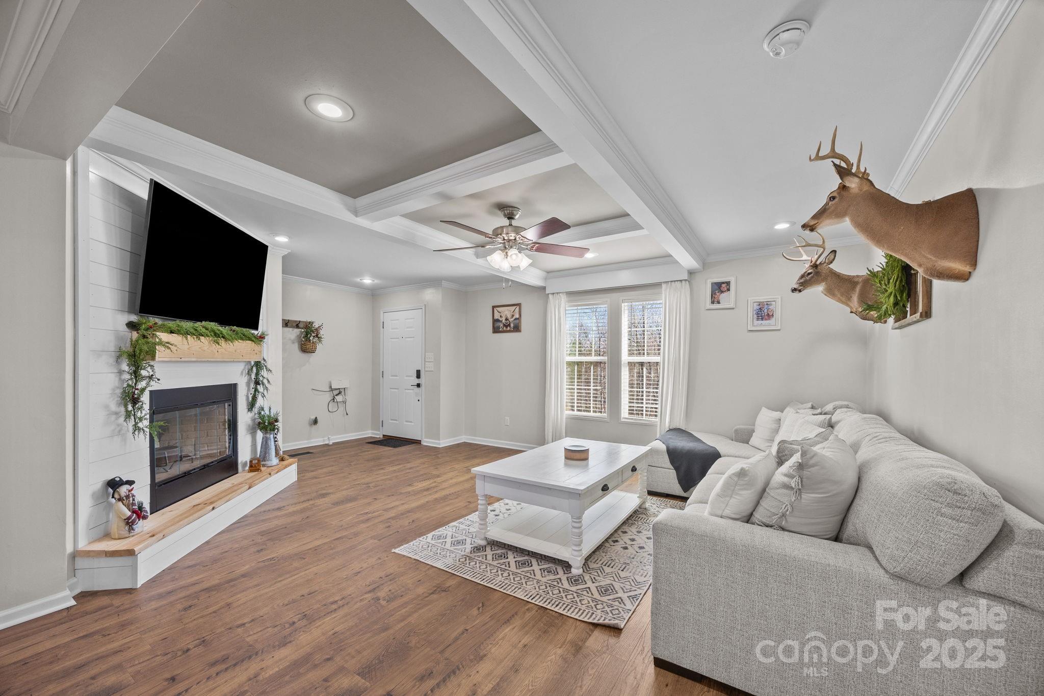 247 Aden Green Road Mill Spring, NC 28756 - Photo 10 of 48 a living room with furniture a fireplace and a flat screen tv