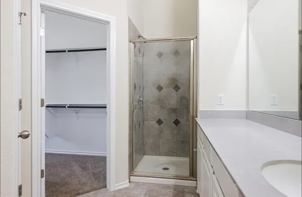 a bathroom with a granite countertop shower mirror and a sink