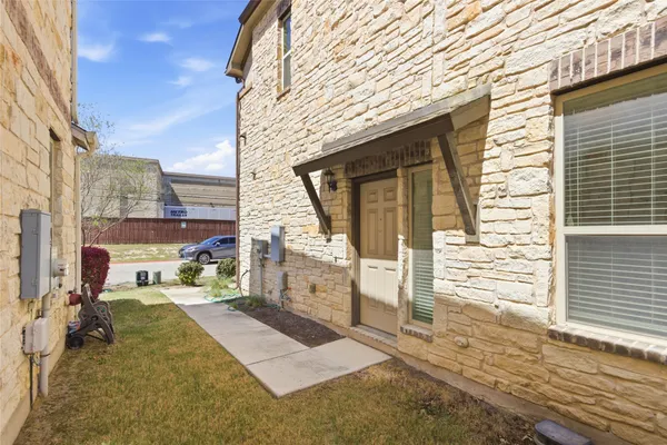a view of a brick house with many windows
