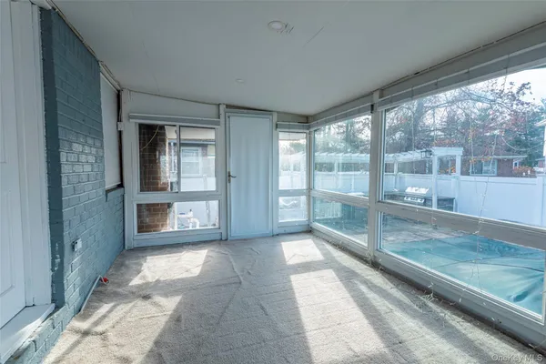 a view of a room with large windows