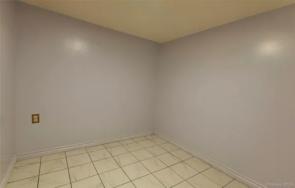 a view of a livingroom with an empty space and a window
