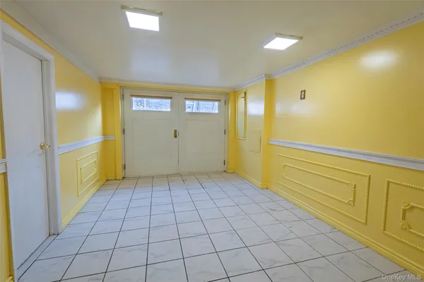 a view of a hallway with closet and bathroom