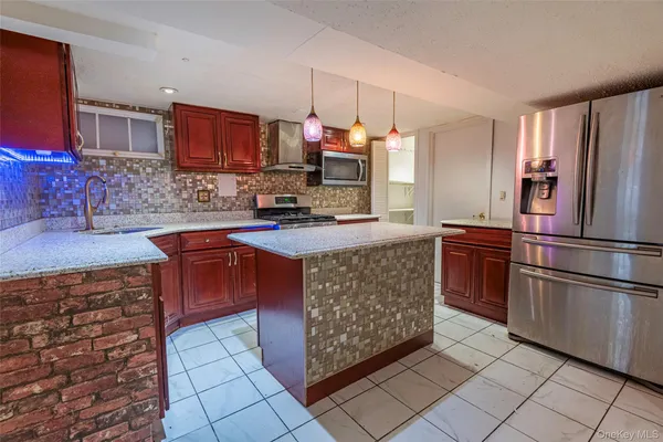 a kitchen with stainless steel appliances granite countertop a refrigerator sink and cabinets