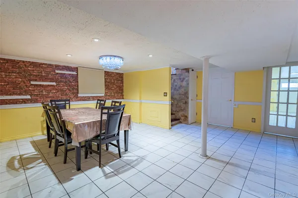 a view of a kitchen with furniture and a refrigerator