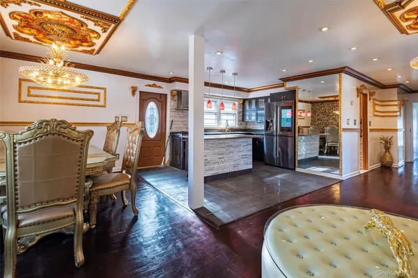 a view of a hallway with furniture and wooden floor