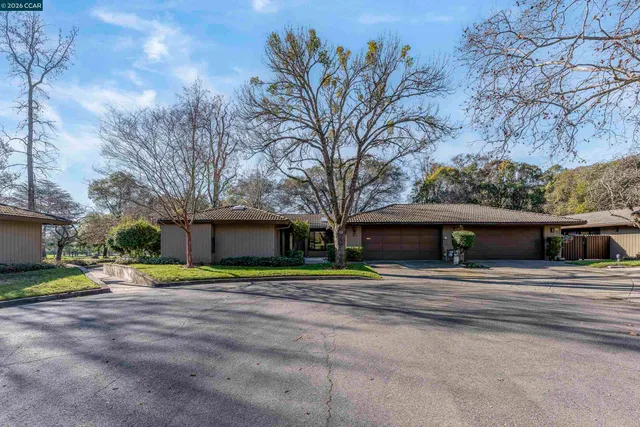 an empty room with windows and fireplace