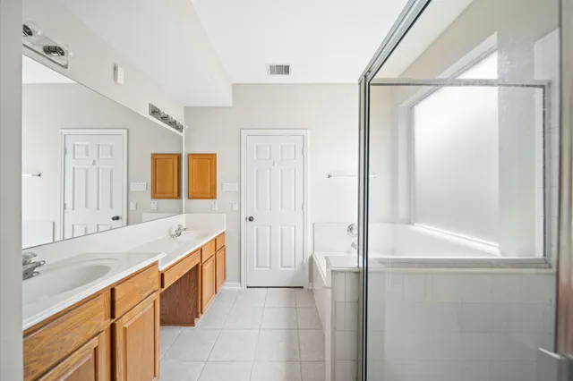 a bathroom with a tub and shower
