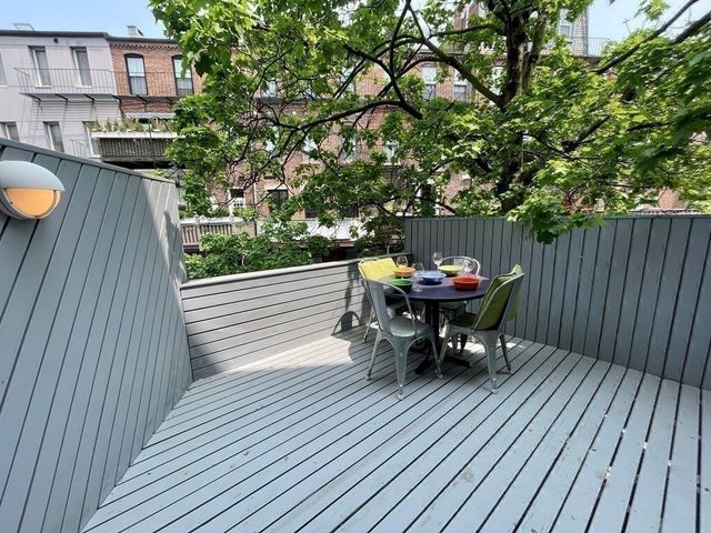 a terrace with outdoor seating and city view