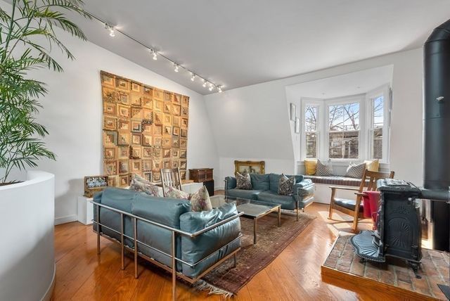 a view of a roof deck with table and chairs with wooden floor and fence