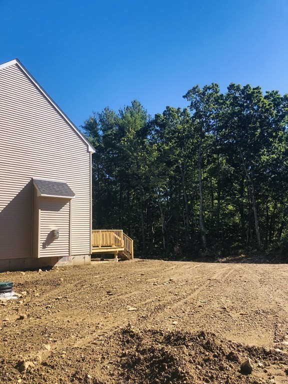 145 Turkey Hill Road Rutland, MA 01543 - Photo 3 of 22 a backyard of a house with large trees and covered with tall trees