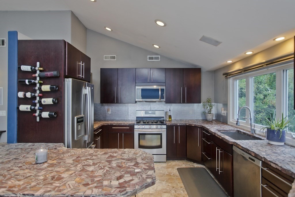 98 Greenwich Road Ware, MA 01082 - Photo 3 of 22 a kitchen with stainless steel appliances granite countertop sink stove refrigerator and cabinets