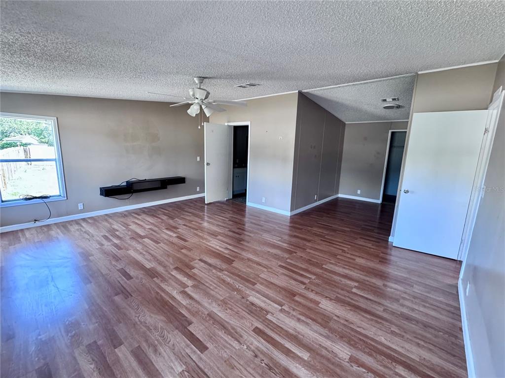 4300 Meadow Ridge Avenue Mulberry, FL 33860 - Photo 11 of 25 an empty room with wooden floor and windows