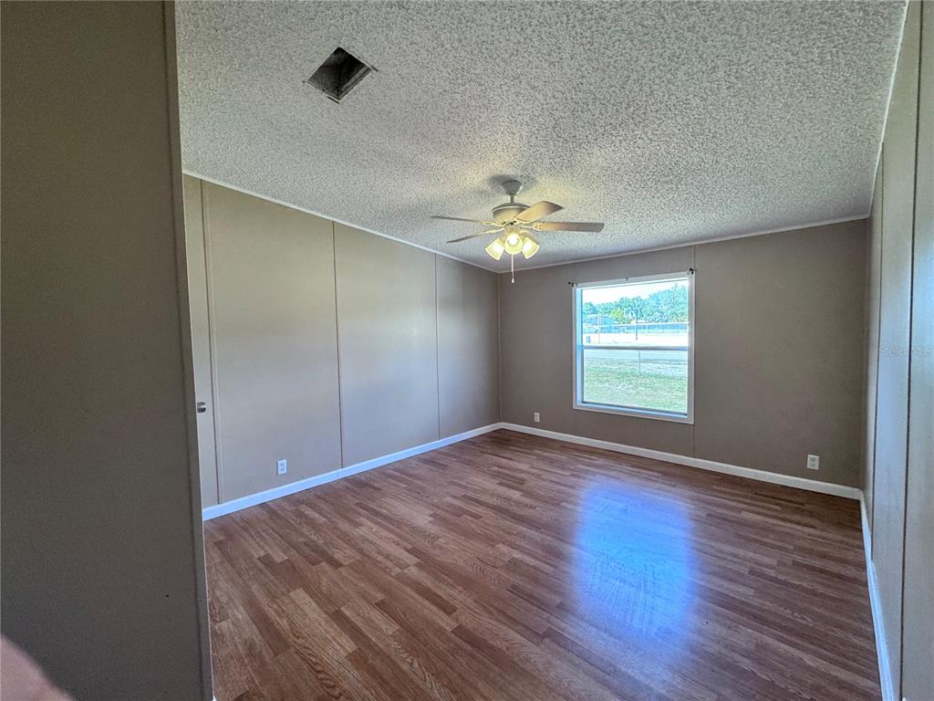 4300 Meadow Ridge Avenue Mulberry, FL 33860 - Photo 14 of 25 wooden floor in an empty room with a window