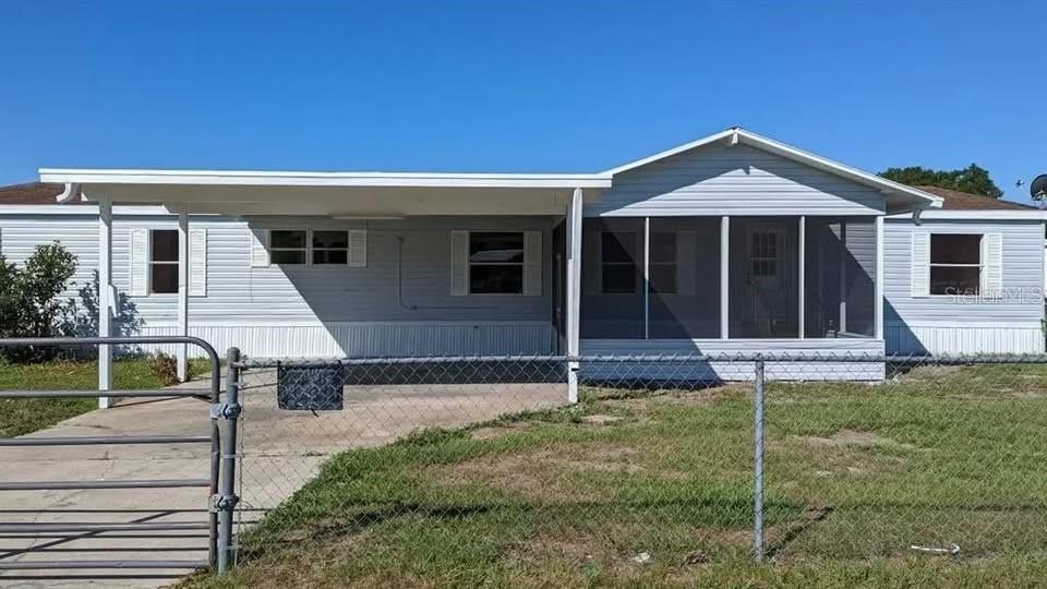 4300 Meadow Ridge Avenue Mulberry, FL 33860 - Photo 2 of 25 a front view of a house with yard