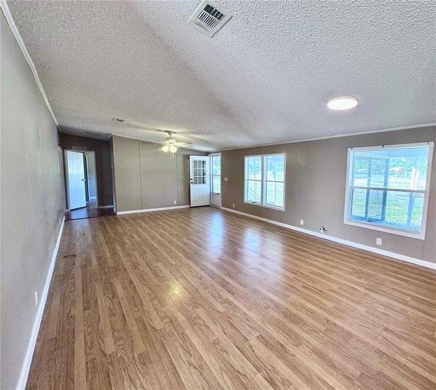 4300 Meadow Ridge Avenue Mulberry, FL 33860 - Photo 9 of 25 wooden floor in an empty room with a window