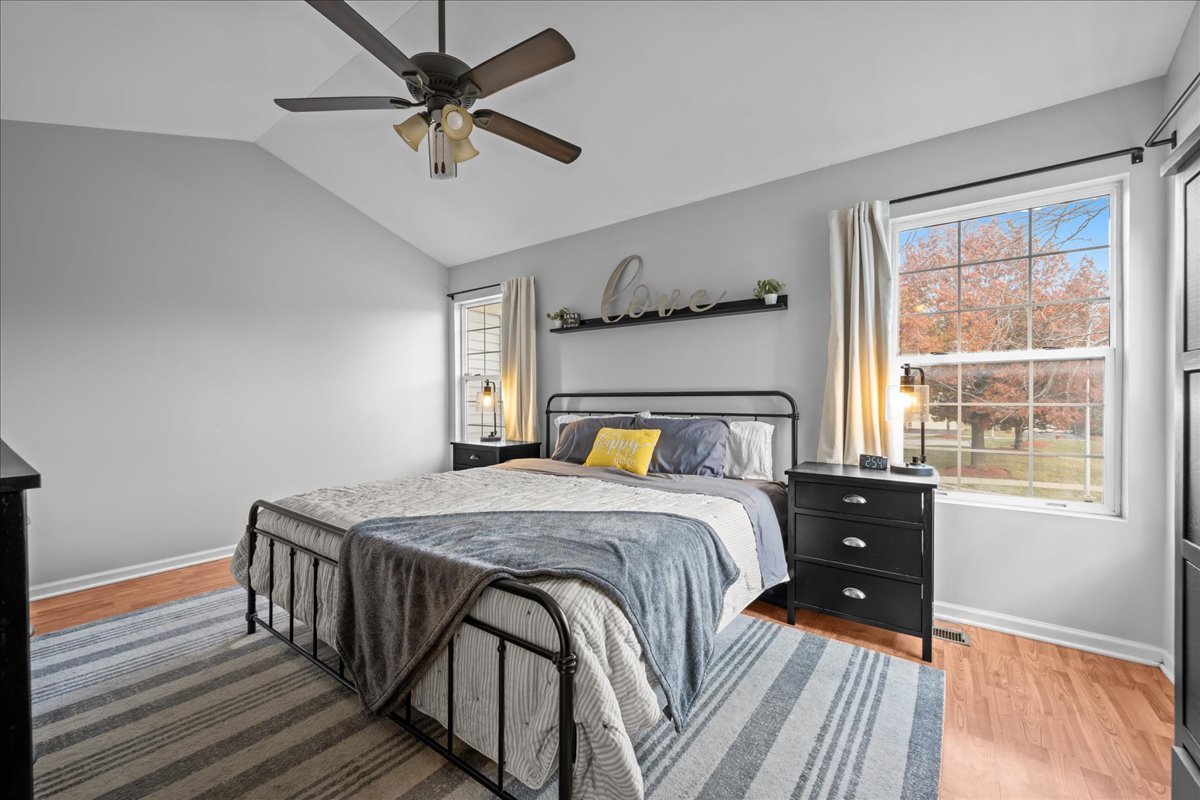 8 Ione Drive, Unit C South Elgin, IL 60177 - Photo 15 of 31 a bedroom with a bed and wooden floor