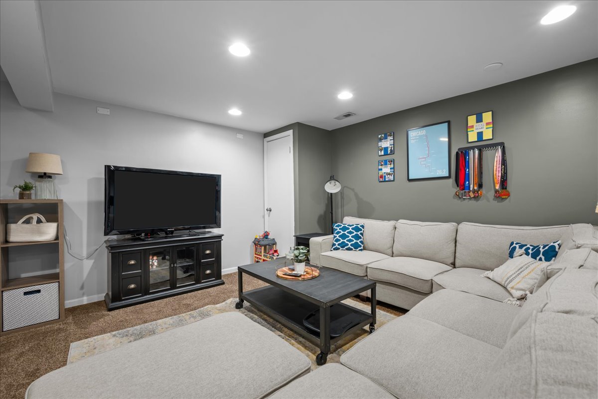 8 Ione Drive, Unit C South Elgin, IL 60177 - Photo 21 of 31 a living room with furniture and a flat screen tv