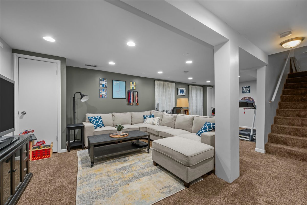 8 Ione Drive, Unit C South Elgin, IL 60177 - Photo 22 of 31 a living room with furniture and a flat screen tv