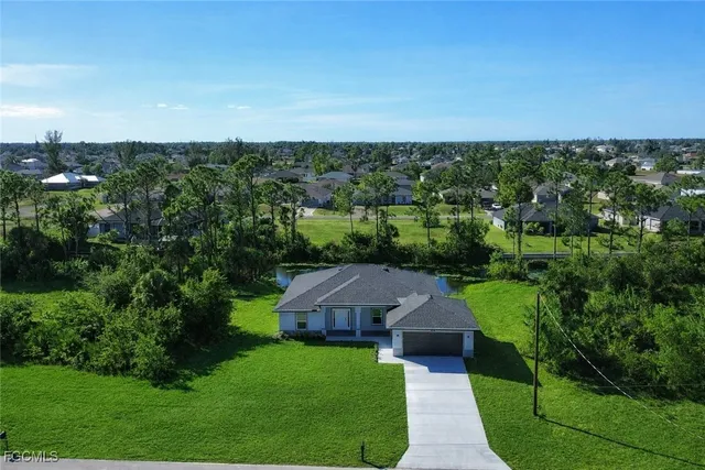 an aerial view of a house with a yard