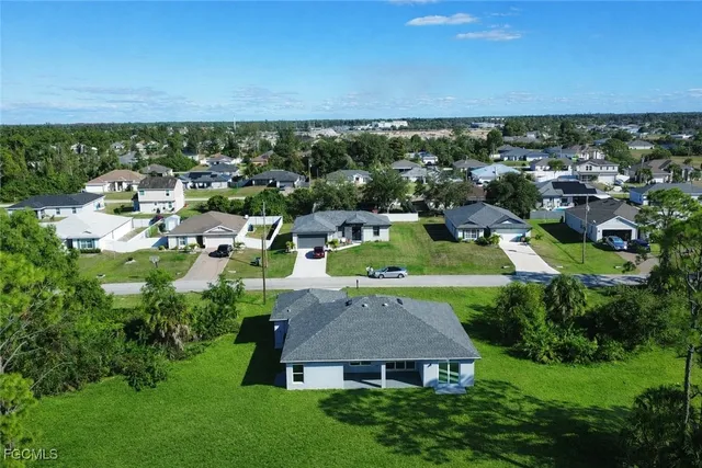 a aerial view of a house with swimming pool and green valley