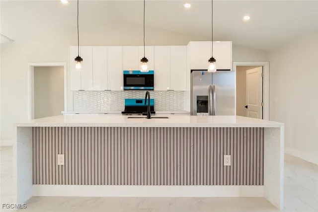 a view of kitchen with stainless steel appliances kitchen island