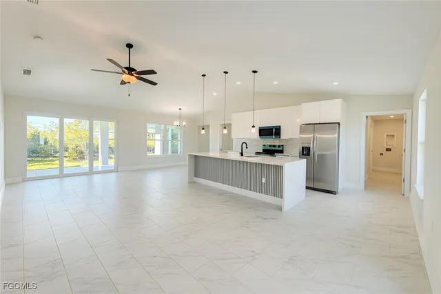 a large kitchen with cabinets and stainless steel appliances