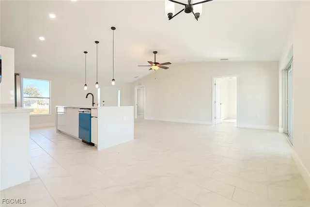 a view of a kitchen with a sink and a chandelier fan