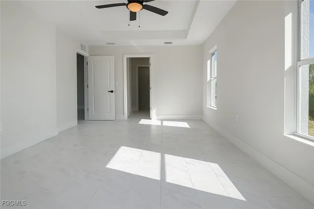 an empty room with windows and entrance