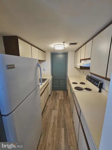 a kitchen with a refrigerator and a sink