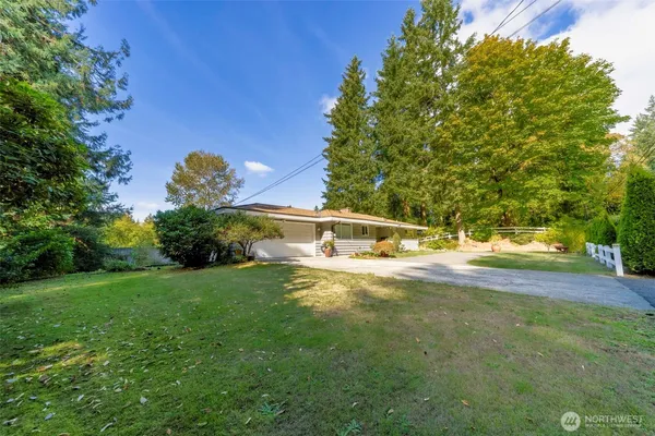 a view of an house with backyard space and garden