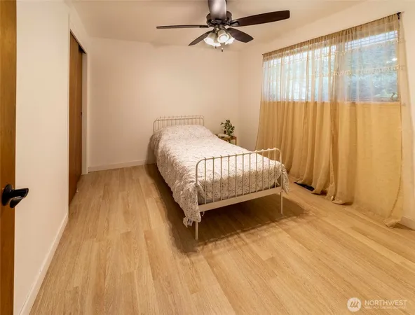 a bed sitting in a bedroom next to a window