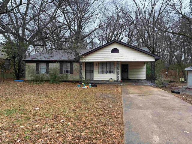 a front view of a house with yard and porch